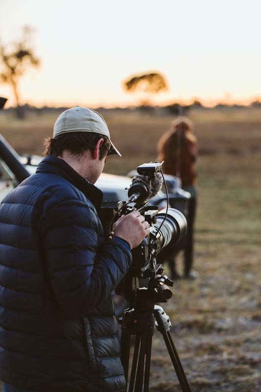 Director of photography, Oli Caldow looking through his camera lens while the Black Bean independent film production company is on assignment for Sanctuary Retreats in Baines Camp.