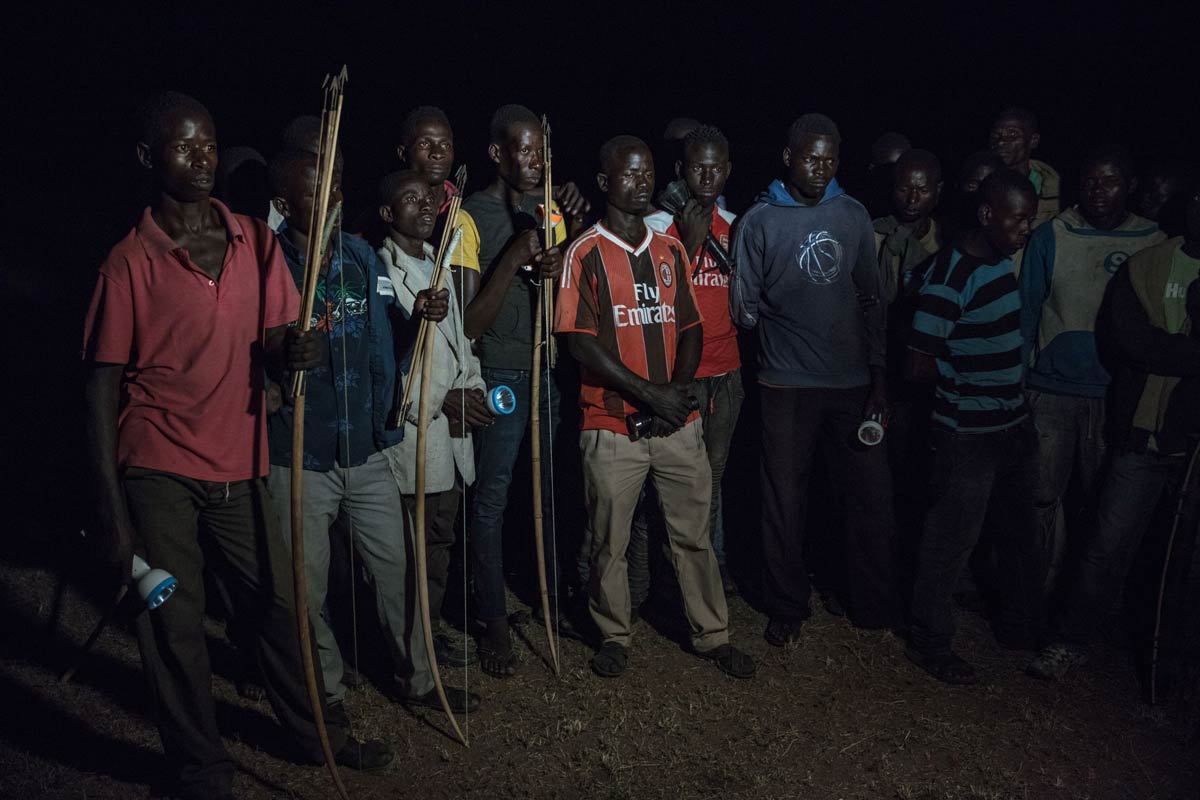A group on men from the local village have gathered in anticipation of a retaliation attack against a predator who has entered their village. Retaliation or revenge attacks happen when animals enter the village and cause damage – either destroying crops, killing livestock or hurting/killing community members – men from the village will come together to try and hunt down the animal or will leave snares or poison.